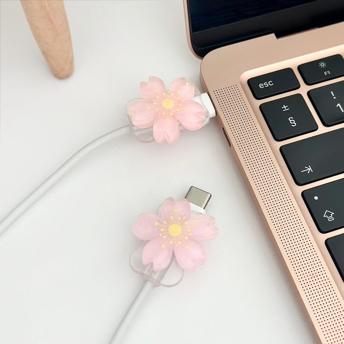 Baby pink flower cable cover charms with a smooth finish, designed to protect and decorate charging cables.