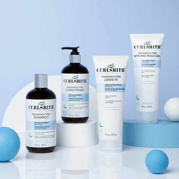 Curlsmith hair care products on a light blue background
