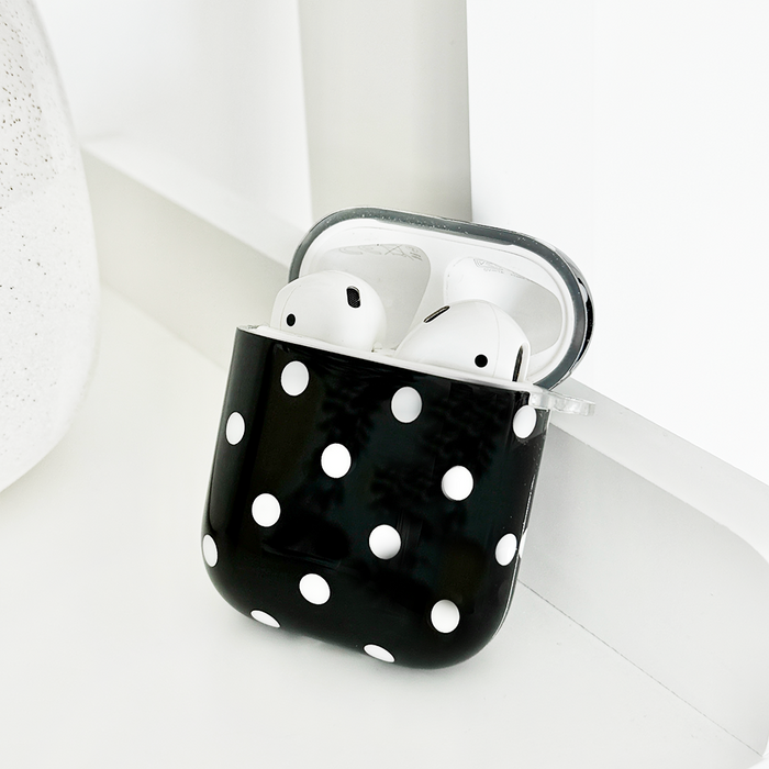 Black AirPods case with white polka dots from Coconut Lane, featuring a smooth, protective finish.
