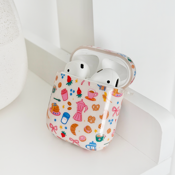 Coconut Lane Airpods case with coffee cup and croissant pattern, pastel colors, smooth finish.