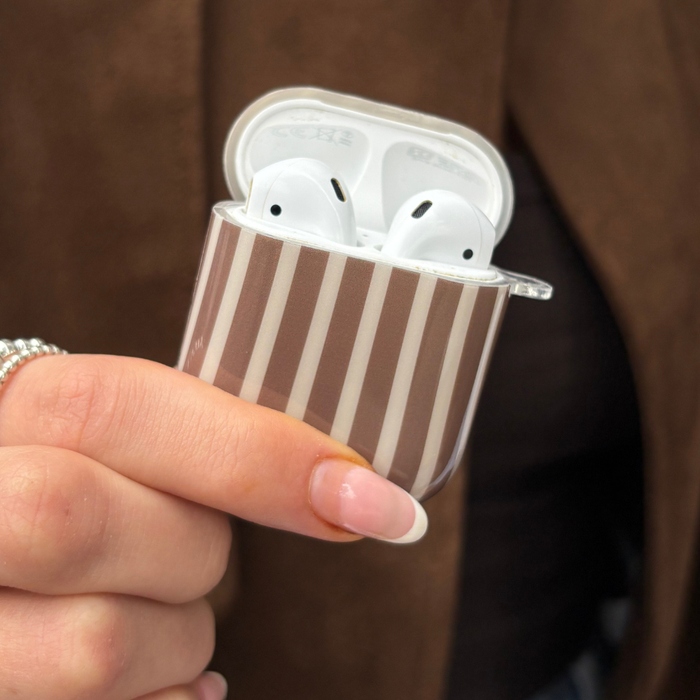 Hand holding Coconut Lane Airpods Case in Chestnut Stripes pattern with a smooth, glossy finish.