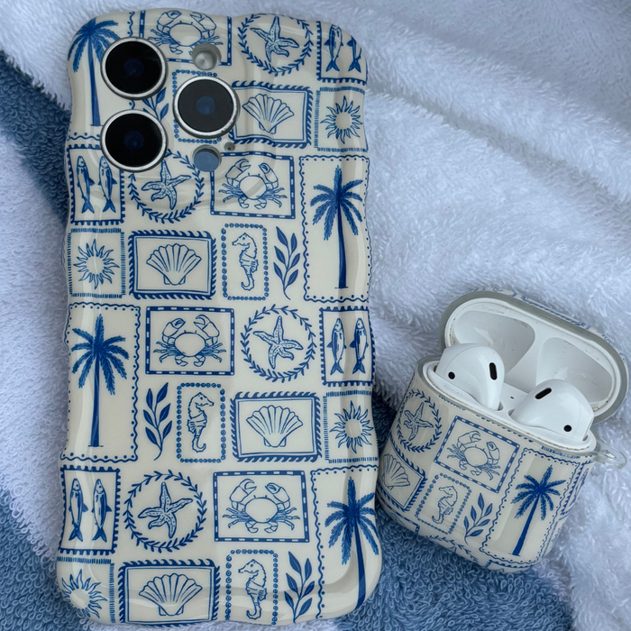 Coconut Lane AirPods case with a blue ocean pattern, made of TPU, shown on a white towel.