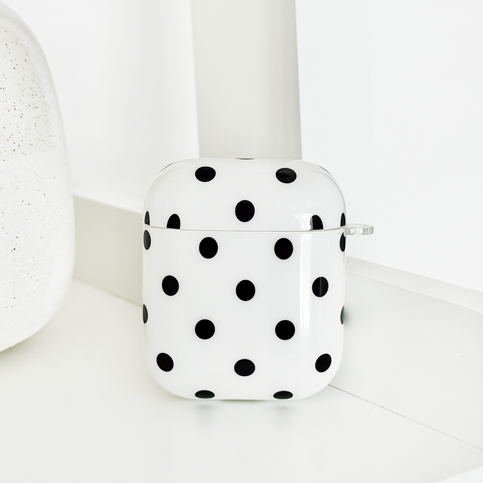 White Airpods case with black polka dots from Coconut Lane.