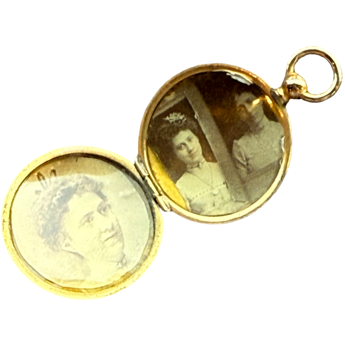 Gold locket with vintage portraits inside on a white background