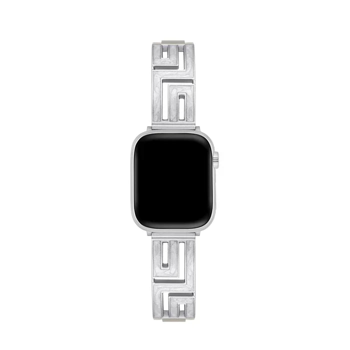 Axiom Link stainless steel Apple Watch band with Greek key cut-out pattern in brushed silver finish on a woman's wrist