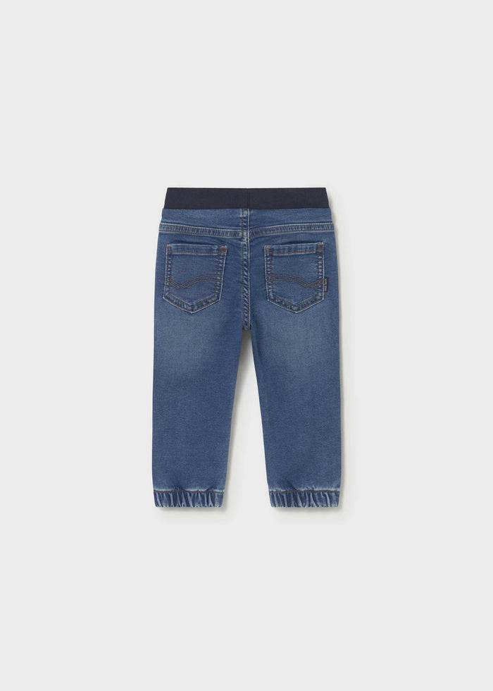 Back view of Mayoral baby boy jogger jeans showing Dark Blue denim wash and cuffed leg openings.