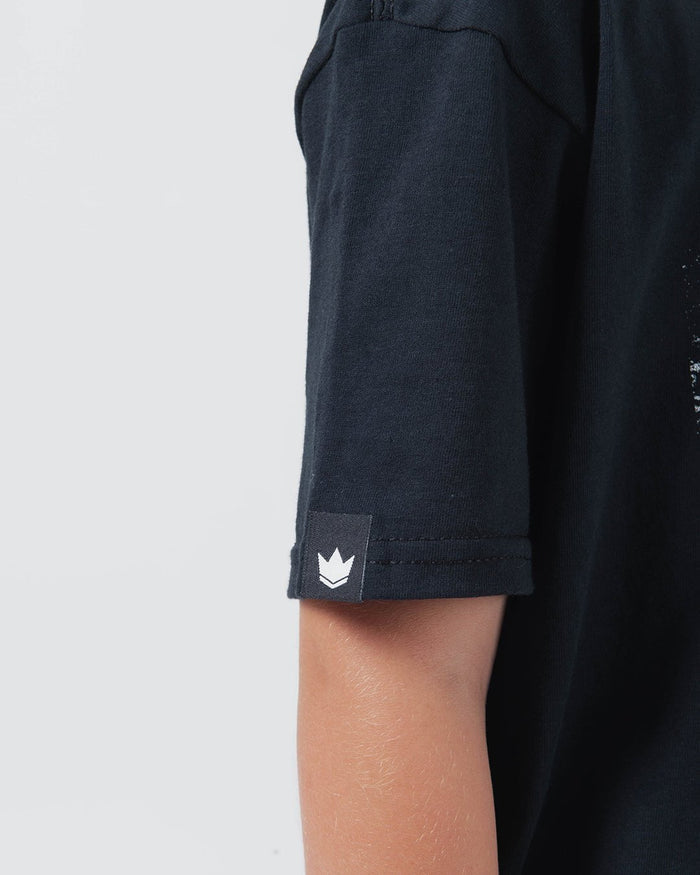 Kingz Be Fluid Youth Tee Black - Close-Up Sleeve View Youth Black Tee White Crown Badge Logo Streetwear Casual Apparel [color:Black]