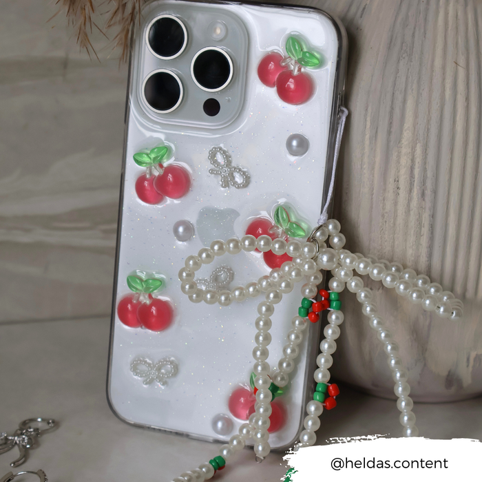 Beaded phone strap with 3D cherry charms, pearl beads, and a small bow on the Coconut Lane Cherry Pearl design.