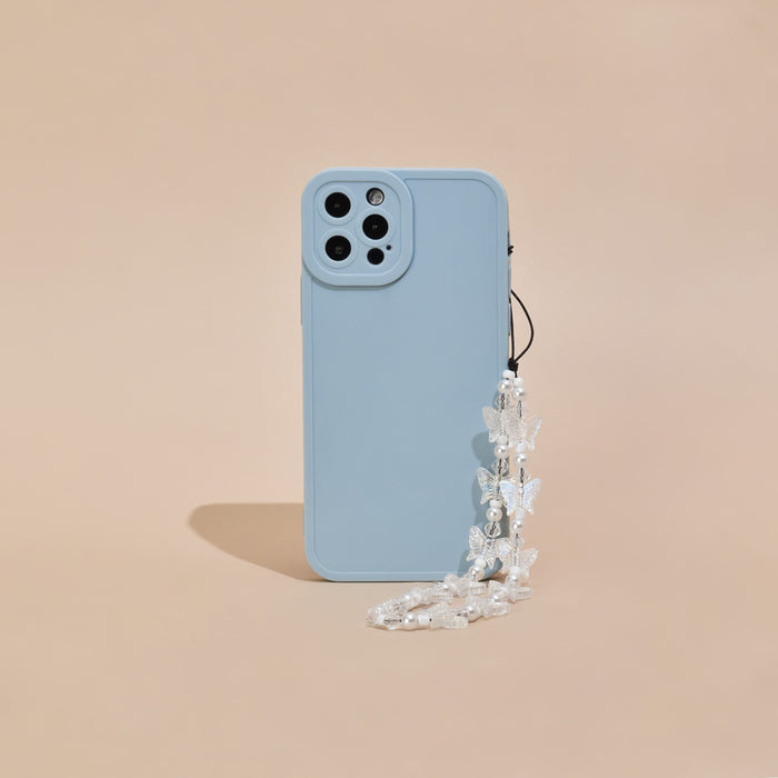 Blue smartphone case with a clear and pearl butterfly beaded phone strap, shown on a beige background.