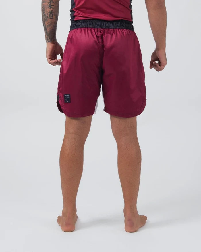 Kingz Born To Rule Shorts Maroon - Back View Male Athlete Black Waistband Maroon Fabric Black Side Panel Subtle Logo Patch Right Leg Athletic Fit Grappling Shorts BJJ Training [color:Black]