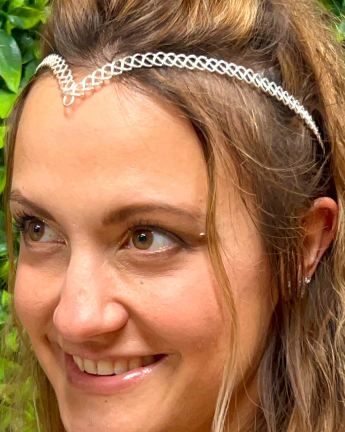Model wearing a silver braided wire crown headband for Renaissance and festival wear.