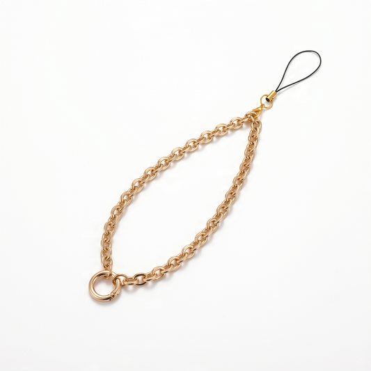 Gold chain phone strap with circle attachment on a white background