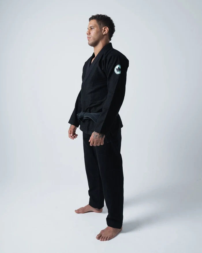 Kingz Classic 3.0 Jiu Jitsu Gi - Black - Side View Male Athlete Black Gi White Crown Badge Left Arm Durable Fabric Traditional Cut BJJ Gi Training [color:Black]