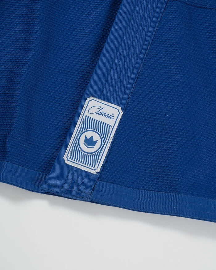 Kingz Classic 3.0 Jiu Jitsu Gi - Blue - Close-Up Detail View Blue Fabric Textured Weave Classic Label White Crown Badge Blue Stitching BJJ Gi Training Apparel [color:Blue]