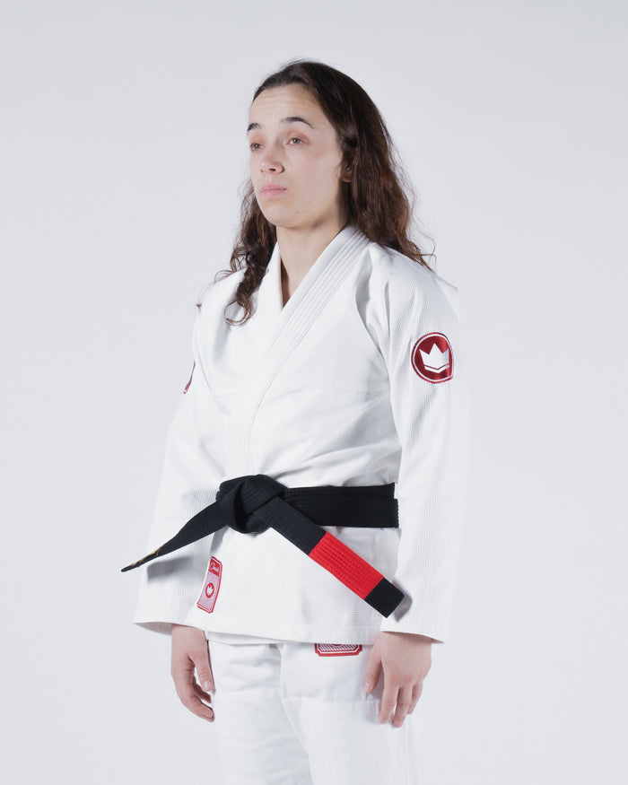 Kingz Classic 3.0 Women's BJJ Gi White - 3/4 Angled Upper Body View Female Athlete Black Belt Red Crown Badge Logo Sleeve