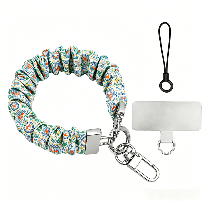 A Coastal Catch scrunchie phone wrist strap featuring a blue tile, orange lobster, and yellow lemon pattern attached to a matching Wavy Luxe phone case on a blue and white striped background.