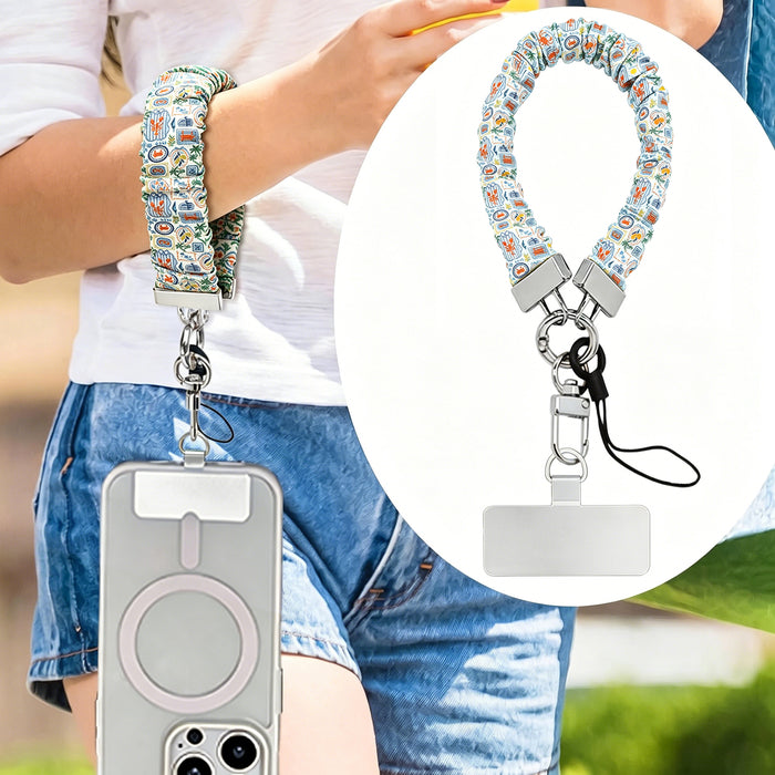A Coastal Catch scrunchie phone wrist strap featuring a blue tile, orange lobster, and yellow lemon pattern attached to a matching Wavy Luxe phone case on a blue and white striped background.