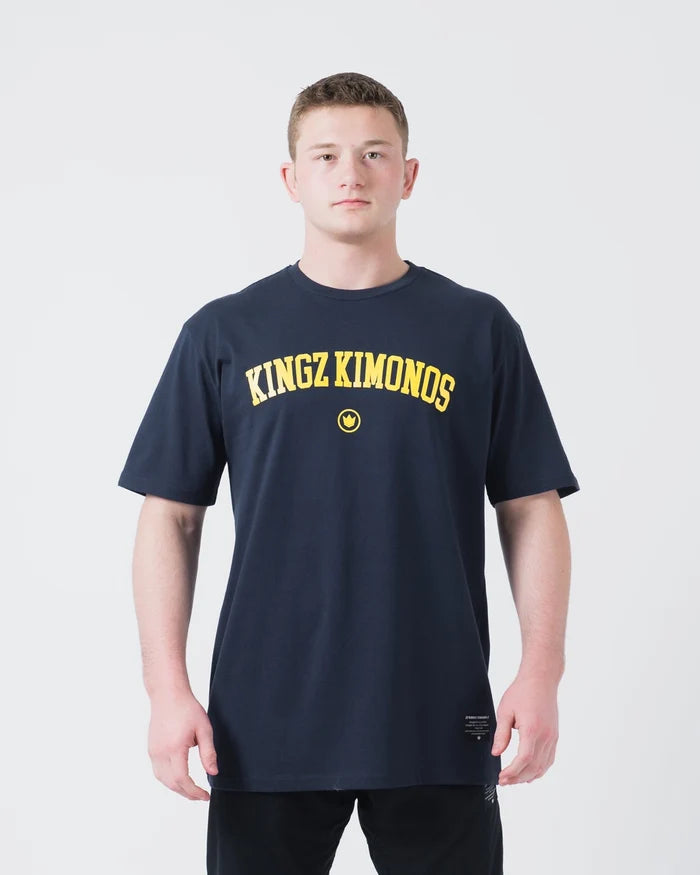 Kingz Collegiate Tee Dark Navy - Front View Male Athlete Yellow KINGZ KIMONOS Text Centered Crown Badge Below Casual Fit T-Shirt BJJ Training Apparel [color:Dark Navy]