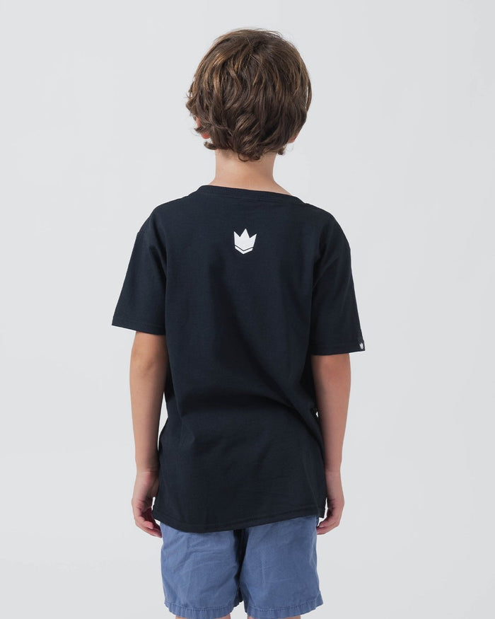 Kingz Collegiate Youth Tee Black - Back View Young Boy White Crown Logo Upper Back Relaxed Fit Short Sleeve Streetwear [color:Black]