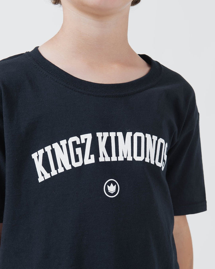 Kingz Collegiate Youth Tee Black - Close-Up Front View Youth Black Tee White KINGZ KIMONOS Arched Text Centered Crown Logo Soft Cotton Streetwear [color:Black]