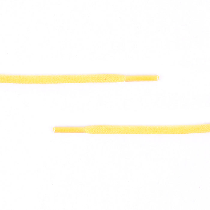 A pair of Colored Flat Waxed Shoelaces by KirbyAllison.com on a white surface.