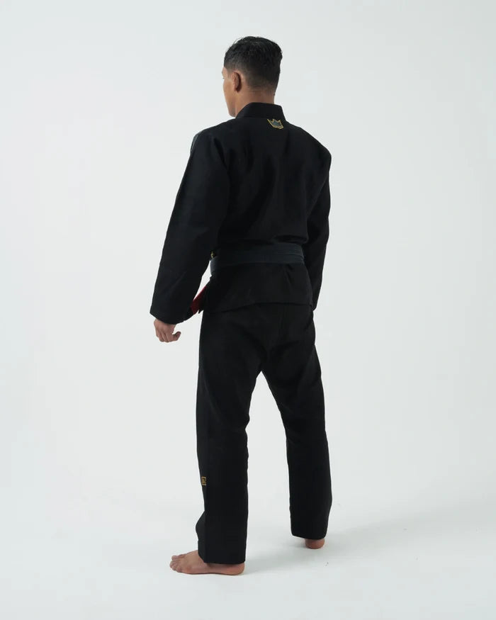 Kingz Comp 450 V6 BJJ Gi Black 2023 version angled pose showing gold crown sleeve embroidery