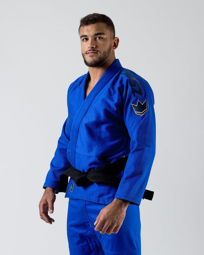 Kingz Comp 450 V6 Gi Blue - Front View Male Athlete Embroidered Crown Badge Left Shoulder Black Belt Contrast Stitching Durable Weave Premium Fit Jiu Jitsu Gear [color:Blue]
