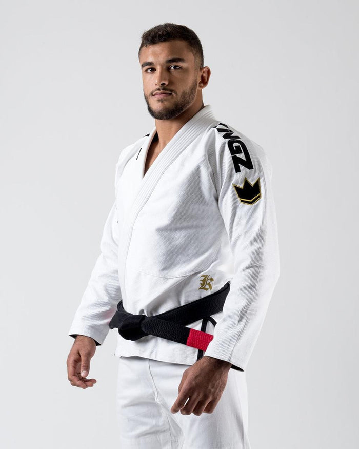 Kingz Comp 450 V6 Gi - White - Three-Quarter Body View Male Athlete Black Belt Shoulder Logo Crown Badge Gold "K" Chest Embroidery Durable Fabric Jiu Jitsu Gear Training Gi [color:White]