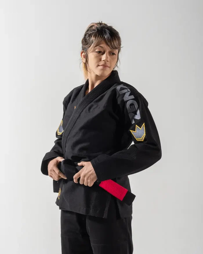Kingz Comp 450 V6 Women's Gi - Black - Front View Female Athlete Black Gi KINGZ Sleeve Text Yellow Crown Badge Shoulder Durable Weave BJJ Training Gi [color:Black]