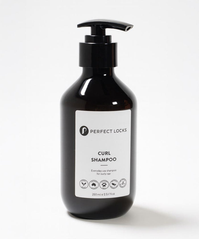 A black pump bottle labeled Perfect Locks Curl Shampoo for curly hair stands against a white background with a sleek label and icons.