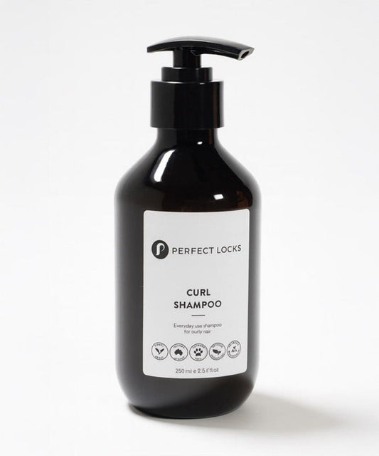 A black pump bottle labeled Perfect Locks Curl Shampoo for curly hair stands against a white background with a sleek label and icons.