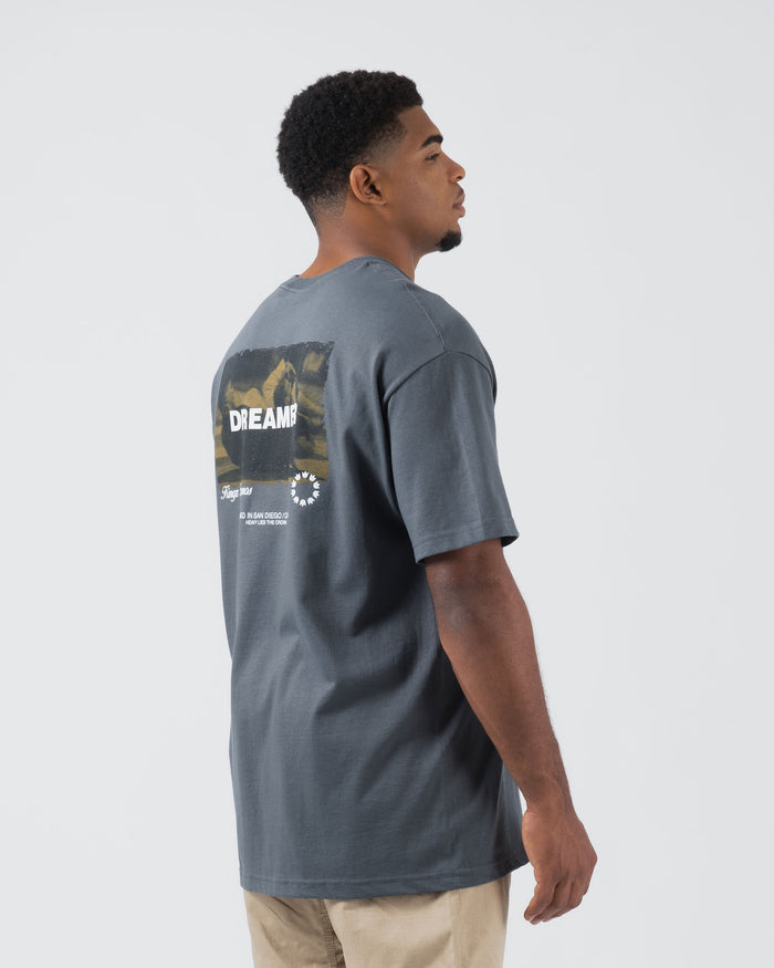 Kingz Dreamer Tee Grey - Side View Male Model Back Graphic DREAMER Text Camo Pattern Large White Logo Lower Back Relaxed Fit Streetwear [color:Grey]