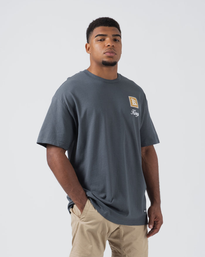 Kingz Dreamer Tee Grey - Front View Male Model Relaxed Fit Short Sleeve Grey Tee Gold Square Logo Left Chest Kingz Script Text Casual Streetwear [color:Grey]