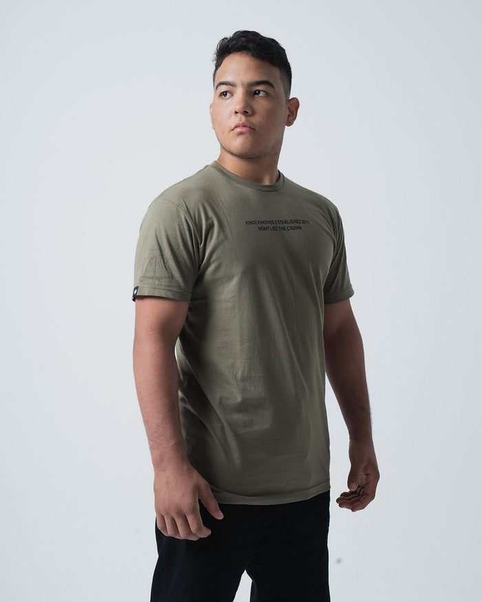 Kingz Est. 2011 Tee Military Green - Three-Quarter Body View Male Model Military Green Crew Neck Short Sleeve Black Text Chest Logo Patch Left Sleeve Casual Streetwear [color:Military Green]