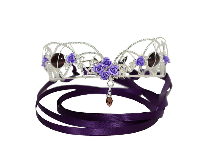 fairy queen crown headpiece in silver wire with purple floral accents and gemstone drop, front view on white background