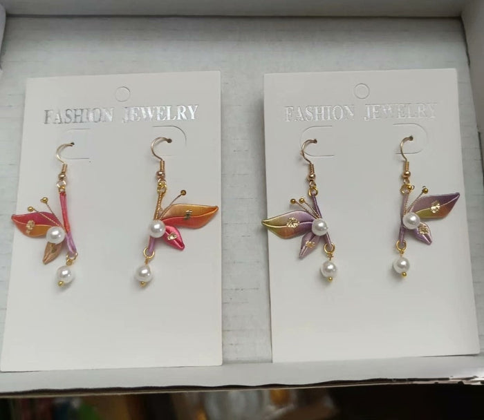 Colorful set of Chanhua butterfly earrings featuring orange, red, and purple ombre silk wings.