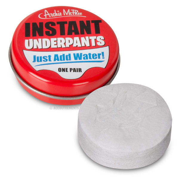 A red container marked Instant Underpants is displayed alongside a compressed white disc, highlighting practical unisex underwear that can be prepared quickly for any unforeseen circumstances.