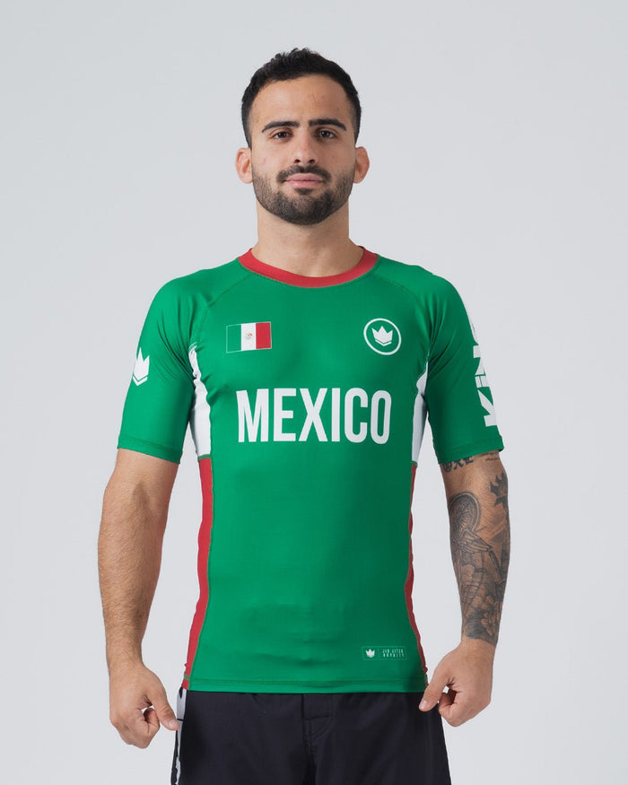 Kingz Jersey Rashguard Mexico Edition - Full Body Front View Male Athlete Short Sleeve Green Body MEXICO White Bold Text Mexican Flag Patch White Crown Logo Red Collar Red Side Stripes KINGZ Sleeve Text BJJ National Pride [color:Green/Mexico]