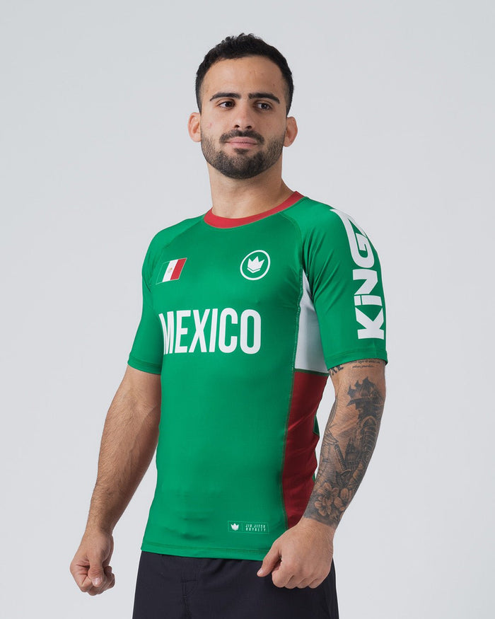 Kingz Jersey Rashguard Mexico Edition - Upper Body Front View Male Athlete Short Sleeve Green MEXICO Text White Panel Right Red Stripe Mexico Flag Crown Logo White KINGZ Right Sleeve Text JIU JITSU ROYALTY Lower Hem BJJ MMA [color:Green/Mexico]