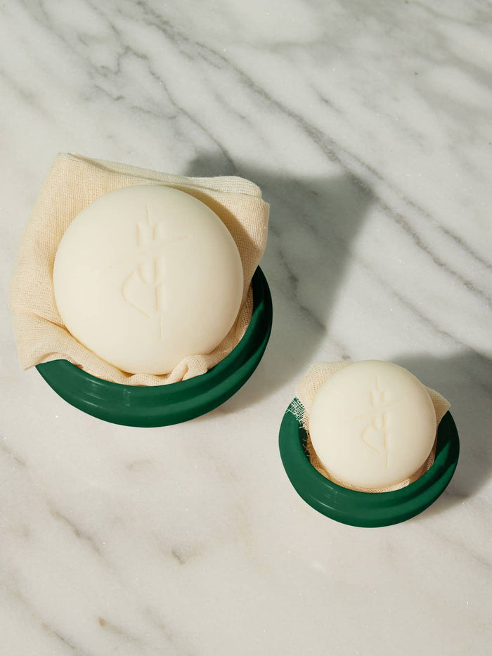 Kate McLeod Body Stone Travel Case in Mint and Pine with a subtly speckled finish and embossed logo.