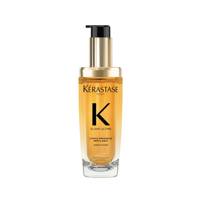 A clear glass bottle with a pump dispenser, containing yellow-hued hair oil, labeled Kérastase Elixir Ultime L'Huile Originale.