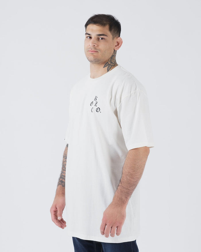Kingz KGZ OE Tee Natural - Side View Male Model Minimalist Black Text Left Chest Short Sleeve Relaxed Fit Streetwear [color:Natural]