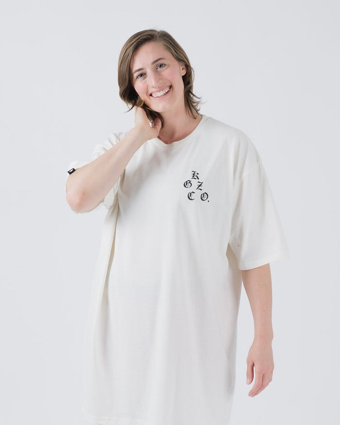 Kingz KGZ OE Tee Natural - Front View Smiling Female Model Short Sleeve Natural Color Black KGZ CO. Chest Logo Relaxed Fit Streetwear [color:Natural]