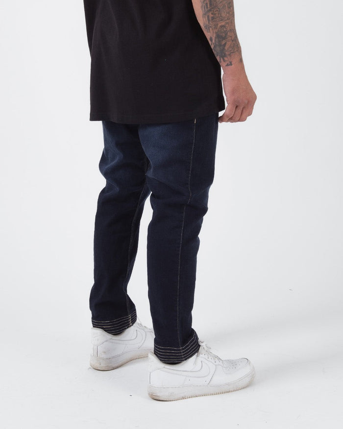 Kingz Casual Gi Pant - Denim - Side View Male Athlete Dark Denim Straight Fit Contrast Stitching White Sneakers BJJ Gi Training Apparel [color:Denim]