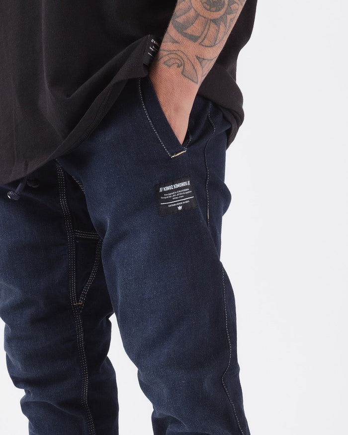 Kingz Casual Gi Pant - Denim - Close-Up Side View Male Athlete Dark Denim Stitching Kingz Kimonos Patch Right Pocket Relaxed Fit BJJ Gi Training Apparel [color:Denim]