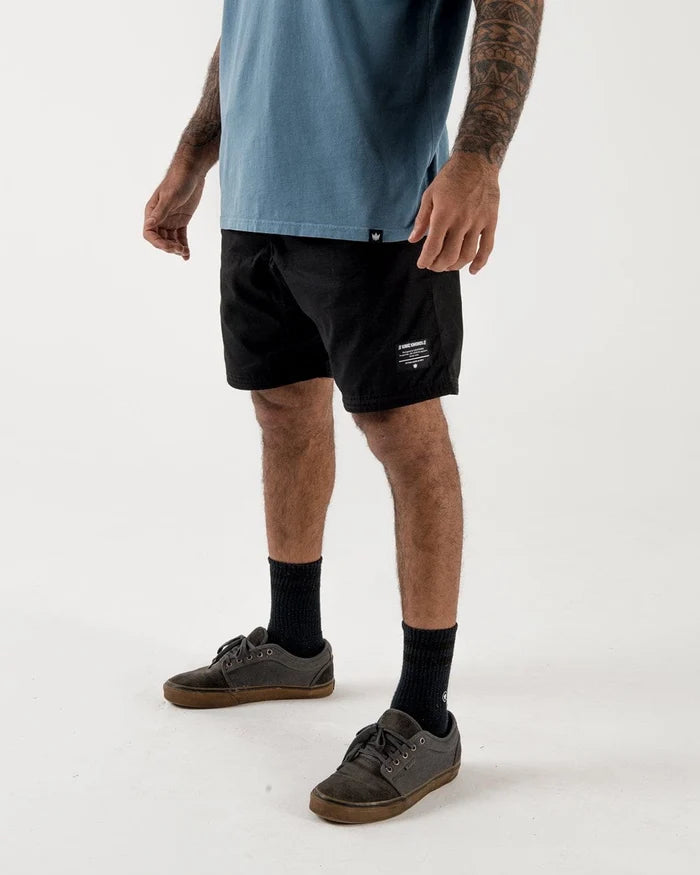 Kingz Casual Gi Shorts - Black - Full Body Front View Male Athlete Black Shorts White Text Patch Left Thigh Relaxed Fit Versatile Design Grappling Shorts BJJ Training [color:Black]