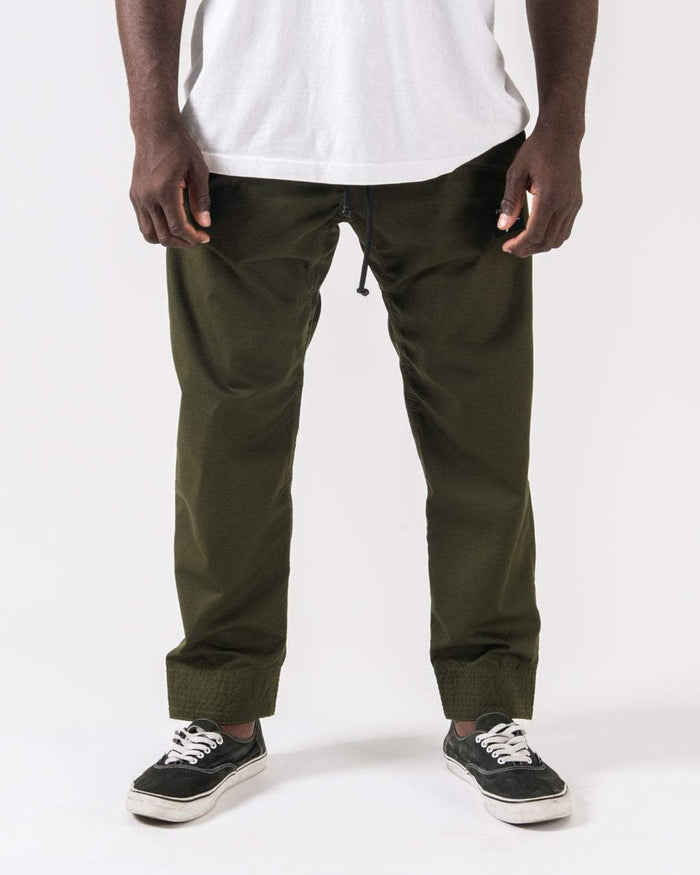 Kingz Casual Rip Stop Gi Pants Military Green - Front View Male Athlete Military Green Drawstring Waist Elastic Cuffs Relaxed Fit Durable Fabric BJJ Gi Training [color:Military Green]