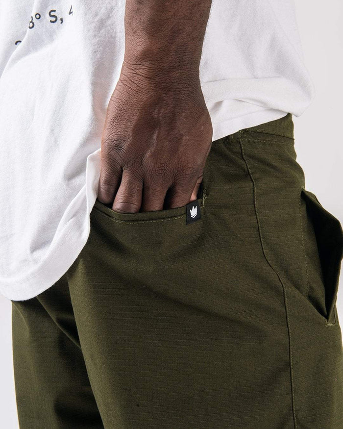 Kingz Casual Rip Stop Gi Pants Military Green - Close-Up Side View Hand in Pocket Crown Badge Black Tag Rip Stop Fabric Texture BJJ Gi Training Apparel [color:Military Green]