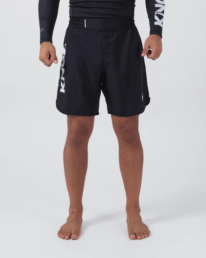 Kingz Kore V2 Shorts Black - Full Body Front View Male Athlete Black Lightweight Grappling Shorts Large KINGZ White Text Left Outer Thigh Crown Logo Right Thigh Elastic Waistband Competition Cut Mid-Thigh Length Black KINGZ Rashguard Bare Feet Men's No-Gi BJJ MMA Kore Collection [color:Black]