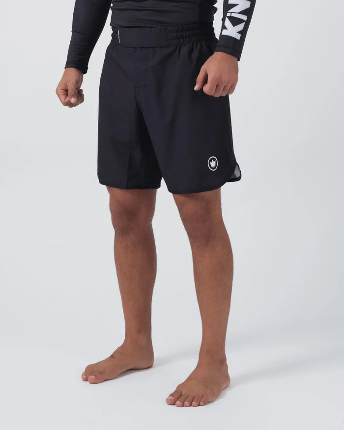Kingz Kore V2 Shorts Black - Full Body Left Side Profile Male Athlete Black Grappling Shorts Crown Logo White Emblem Right Outer Thigh Elastic Waistband Inner Compression Short Visible Hem Competition Cut Black KINGZ Rashguard Bare Feet Men's No-Gi BJJ MMA Kore Collection [color:Black]